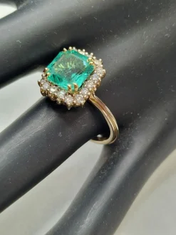 Bague en or jaune avec halo de diamants et émeraude colombienne