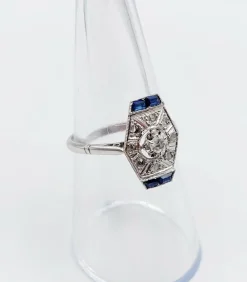 Bague marquise art deco or blanc 18k et platine ornée de diamants taille roses et de saphir calibrés dans une monture géométrique