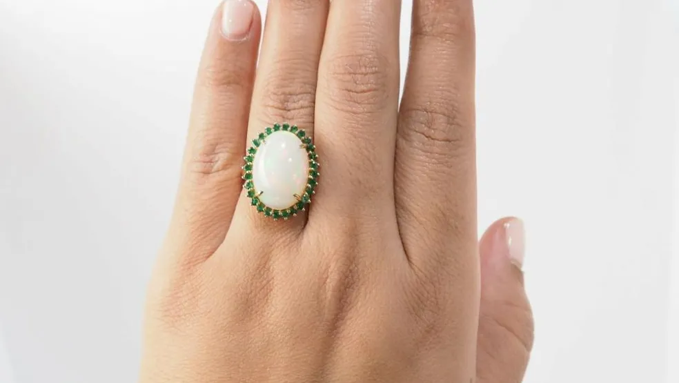 Bague ovale en or jaune, opale cabochon et émeraudes
