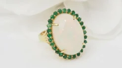 Bague ovale en or jaune, opale cabochon et émeraudes