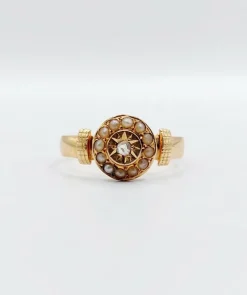 Bague victorienne or rose ornée d'un diamant en serti étoilé entouré de perles