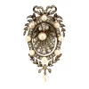 Broche à motif floral et noeud ornée de perles et diamants
