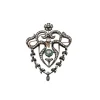 Broche en or et argent avec diamants et émeraudes