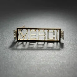 Broche 'Merci" en or jaune 18K et platine, émaillée, encadrée de diamants.