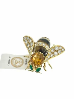 Broche or jaune et pierres précieuses signé René Kreiss