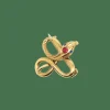 Broche Serpent or jaune, rubis, topaze