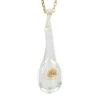 Chaîne en or et son pendentif en verre et paillettes dorées
