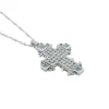 Collier crucifix en or blanc, diamants et aigue-marine