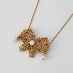 Collier nœud en Or jaune, perles & diamants