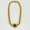 Collier or jaune diamants centré d'une pièce de bronze