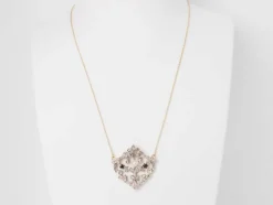 Collier volutes en or jaune et argent, grenat diamants et perle