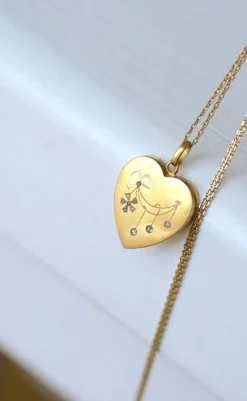 Médaillon cœur ouvrant en or, diamants, et perles